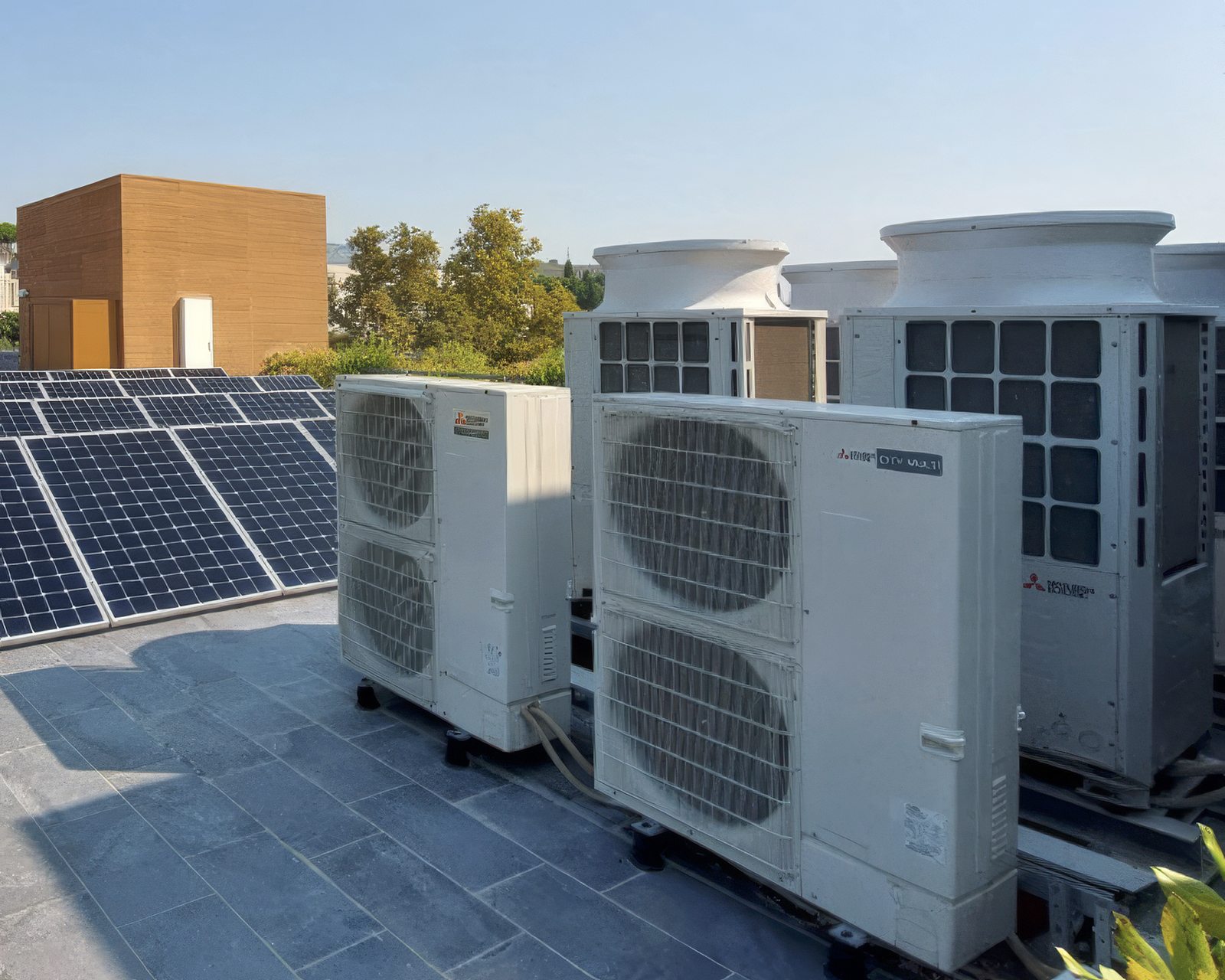 Industrial climate control units monitored by NHP on a roof with photovoltaics
